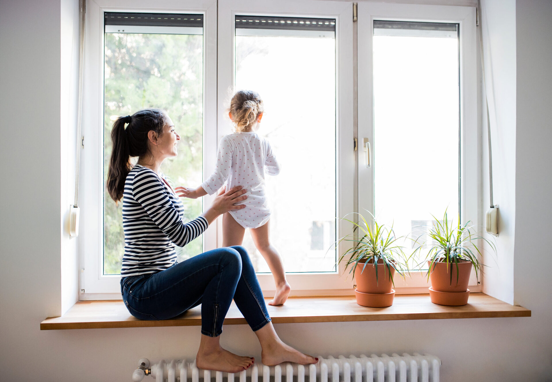 Mother and daughter enjoying the view from a new window